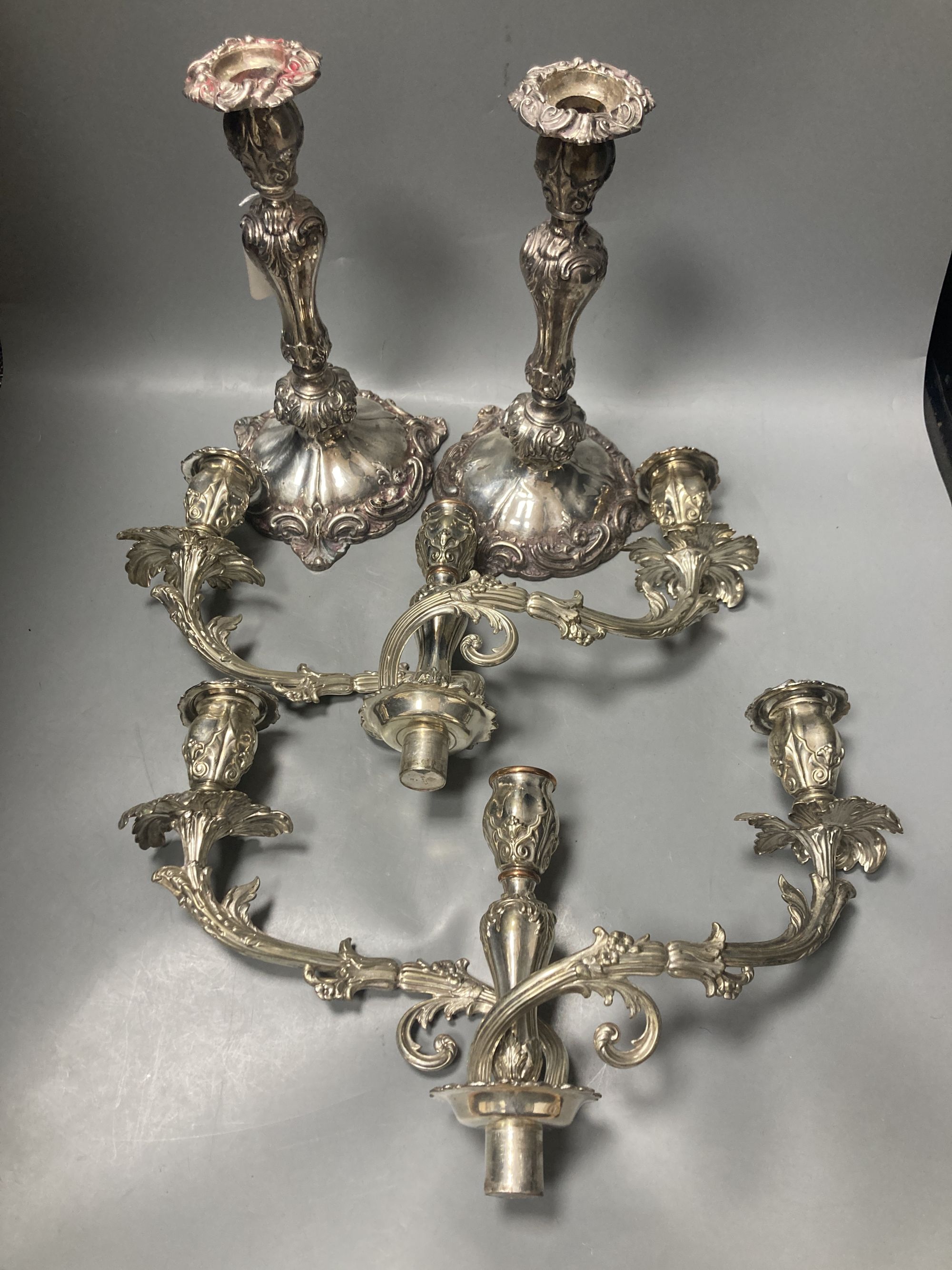 A pair of early Victorian silver candlesticks, indistinct makers mark, Sheffield, 1840, 29cm, weighted (a.f.) & later arms.